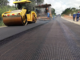 Asphalt is applied with a tar machine and then compacted with a roller on HaTelit G