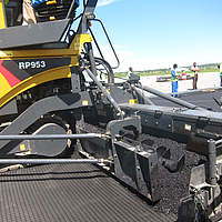 Close-up of a tar machine covering a HaTelit layer with asphalt