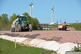 Temporary construction road is driven on by a tractor