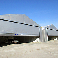 2 Silver Tectura folding front on helicopter hangar