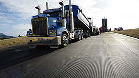 Truck transports raw asphalt over HaTelit XP grid