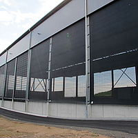 Clad warehouse with black windbreak nets