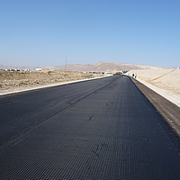 Unfinished road shows HaTelit layer without asphalt pavement