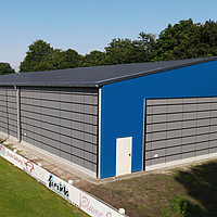 Gray folding fronts on the front and long side of a blue sports hall