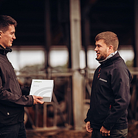 two people talking while one person holds a Lubratec SmartBox package